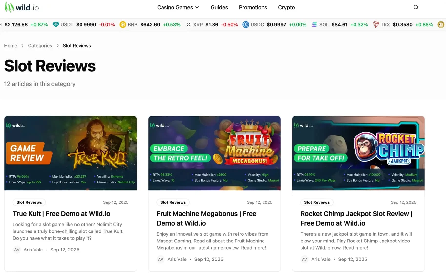Wild.io Slot Reviews category page displaying slot review cards for True Kult, Fruit Machine Megabonus, and Rocket Chimp Jackpot with RTP, volatility, and multiplier information.